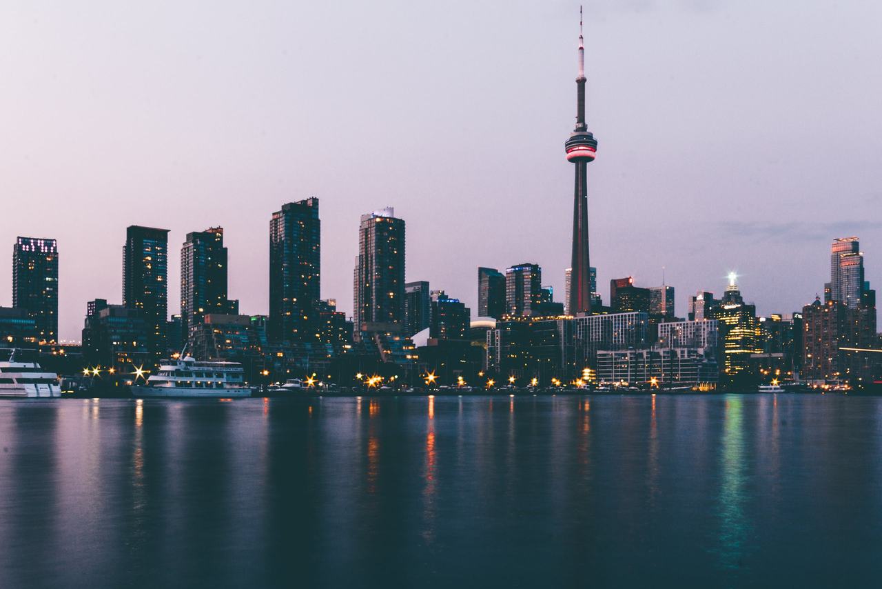 The Toronto skyline and CN Tower at dusk, seen across Lake Ontario